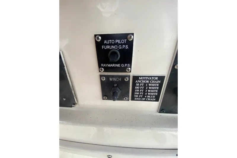 Slide: The Image of Control panel of a 1984 Hatteras 46 Convertible with autopilot and winch switches. - 29