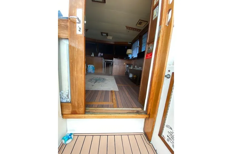 Slide: The Image of Interior view of 1984 Hatteras 46 Convertible yacht with wooden flooring and cozy furnishings. - 40