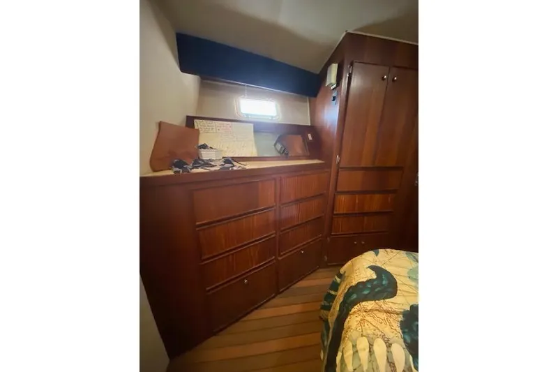 Slide: The Image of Interior of 1984 Hatteras 46 Convertible yacht with wooden cabinetry and cozy decor. - 8