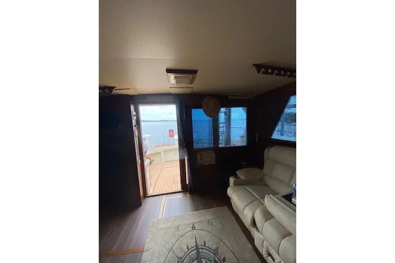 Slide: The Image of Interior of 1984 Hatteras 46 Convertible yacht with seating and view of deck. - 41