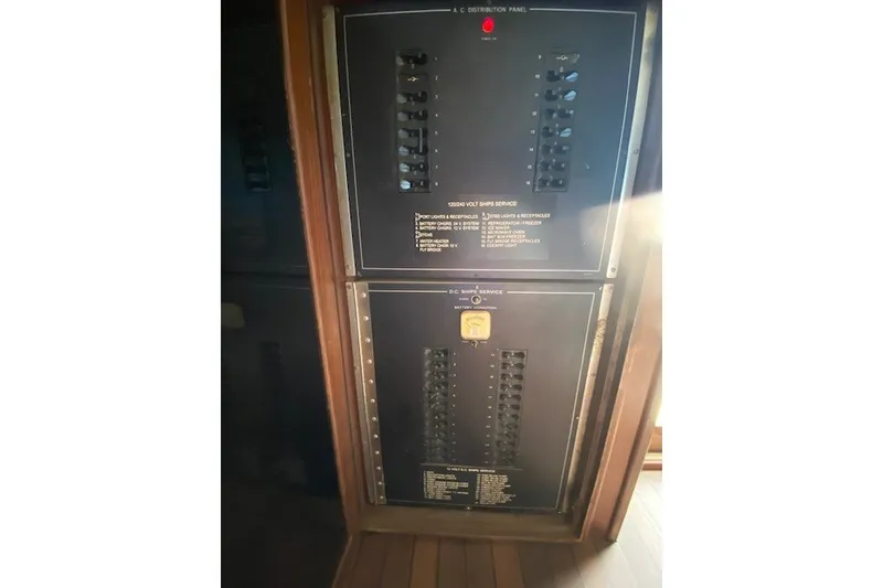 Slide: The Image of Electrical panel on a 1984 Hatteras 46 Convertible yacht, featuring circuit breakers and controls. - 19