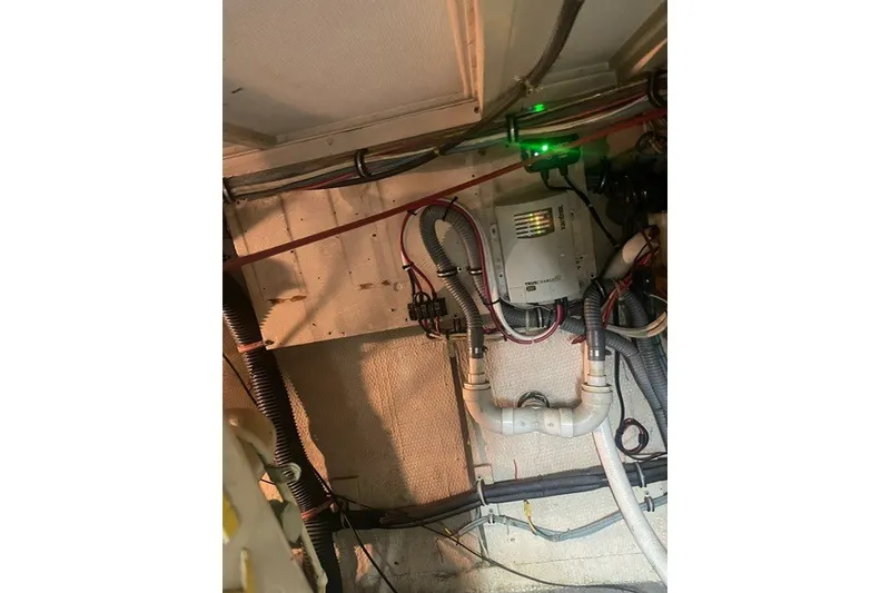 Slide: The Image of Engine room wiring and equipment in a 1984 Hatteras 46 Convertible boat. - 46