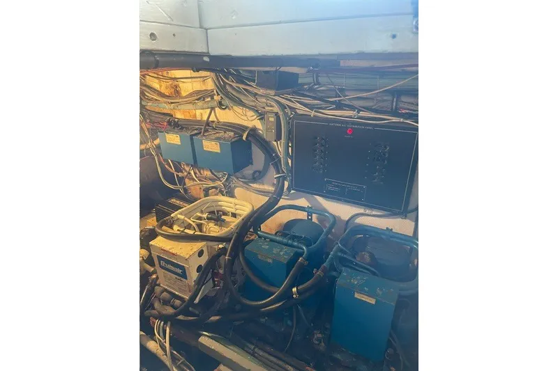 Slide: The Image of Engine room of 1984 Hatteras 46 Convertible with electrical components and wiring. - 52