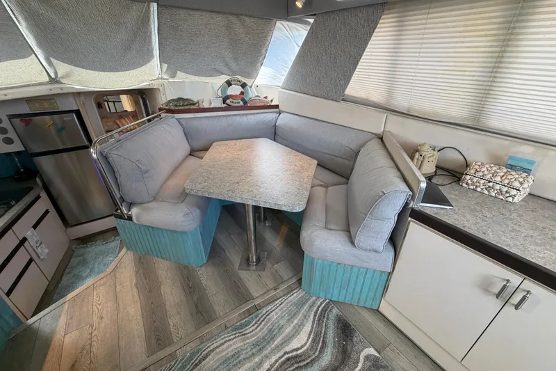 Slide: The Image of Interior of 1989 Trojan International 12 Meter Motor Yacht with cozy dining area. - 19