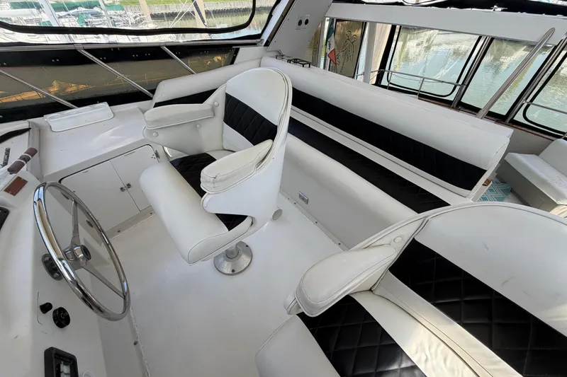 Slide: The Image of 1989 Trojan International 12 Meter Motor Yacht interior with white and black seating. - 12