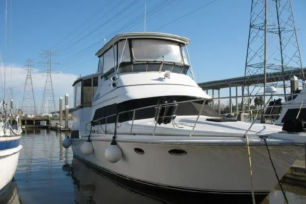 Slide: The Image of 1989 Trojan International 12 Meter Motor Yacht docked at marina under clear blue sky. - 2