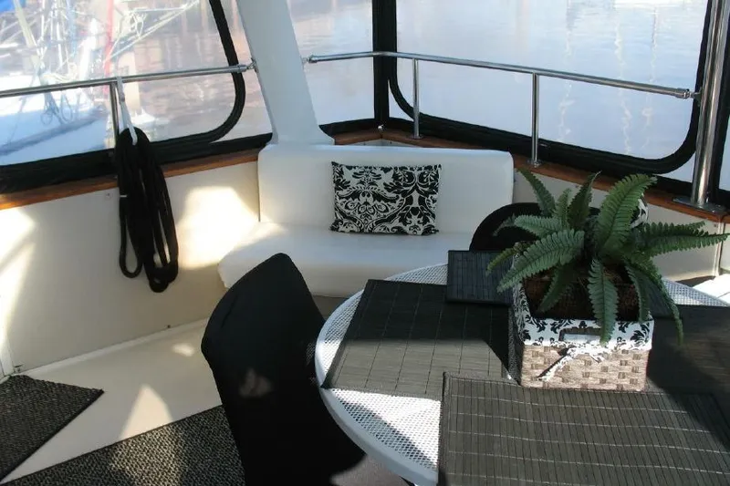 Slide: The Image of Interior of 1989 Trojan International yacht with seating, table, and decorative plant. - 33