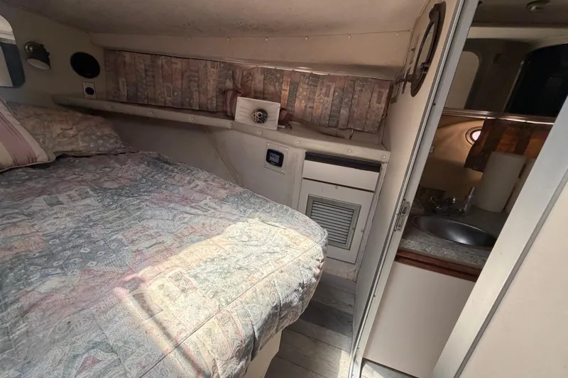 Slide: The Image of Interior of 1989 Trojan International 12 Meter Motor Yacht with cozy bed and compact kitchenette. - 21