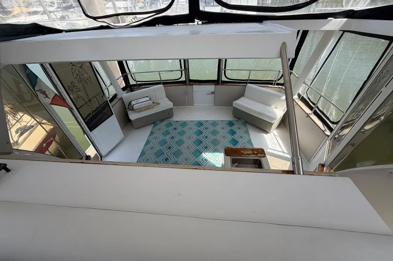 Slide: The Image of Interior of 1989 Trojan International 12 Meter Motor Yacht with seating and patterned rug. - 13