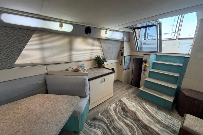 Slide: The Image of Interior of 1989 Trojan International 12 Meter Motor Yacht with seating, stairs, and decor. - 16