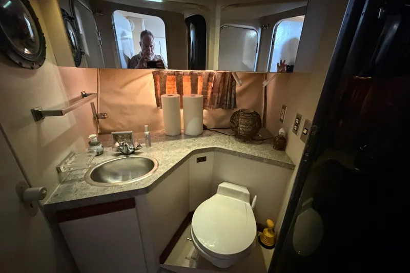 Slide: The Image of Bathroom interior of a 1989 Trojan International 12 Meter Motor Yacht, featuring sink and toilet. - 22