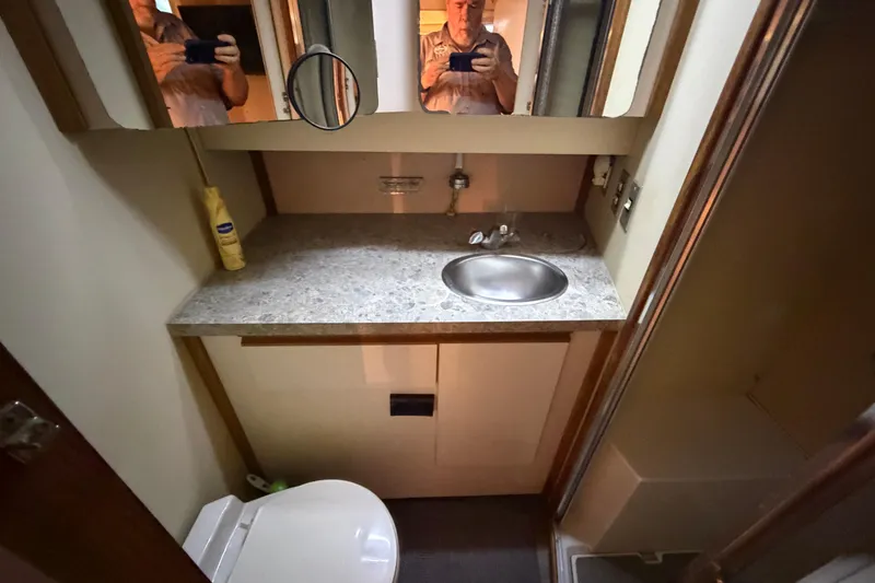 Slide: The Image of Bathroom interior of a 1989 Trojan International 12 Meter Motor Yacht, featuring sink and toilet. - 28