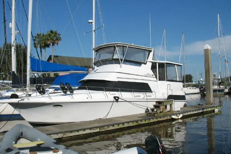 Slide: The Image of 1989 Trojan International 12 Meter Motor Yacht docked at marina under clear blue sky. - 1