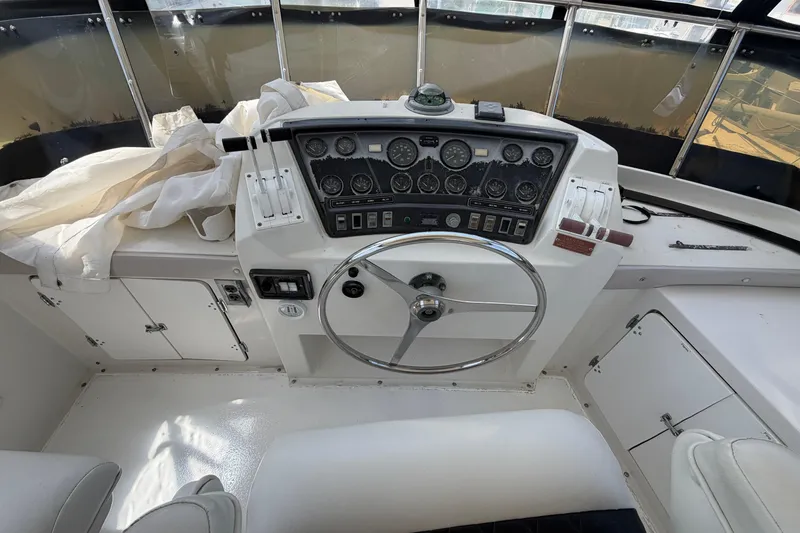 Slide: The Image of Cockpit of 1989 Trojan International 12 Meter Motor Yacht with steering wheel and control panel. - 10