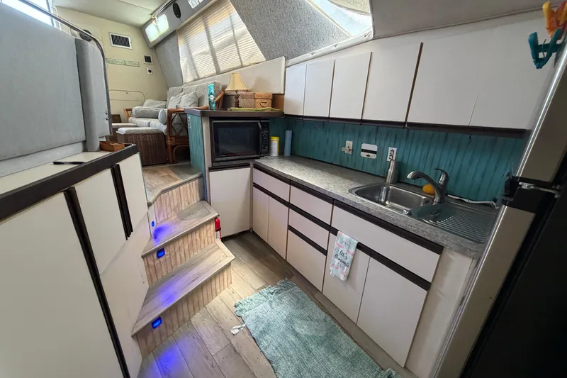 Slide: The Image of Interior of 1989 Trojan International 12 Meter Motor Yacht kitchen area with modern amenities. - 23