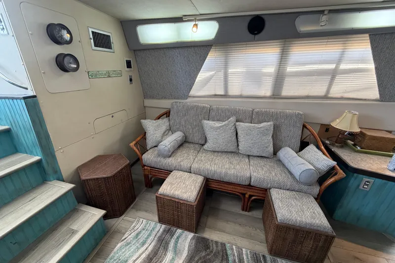 Slide: The Image of Interior of a 1989 Trojan International 12 Meter Motor Yacht with cozy seating area. - 17