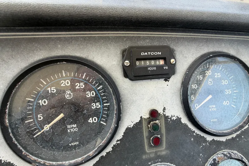 Slide: The Image of Dashboard of a 1989 Trojan International 12 Meter Motor Yacht with gauges and hour meter. - 11