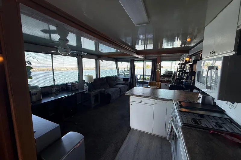Slide: The Image of Interior of a 1997 Fun Country 56 houseboat with kitchen and living area. - 16