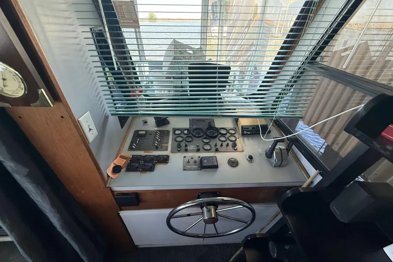 Slide: The Image of Control panel of a 1997 Fun Country 56 houseboat with steering wheel and gauges. - 22