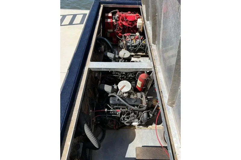 Slide: The Image of Engine compartment of a 1997 Fun Country 56 houseboat, featuring dual engines and mechanical components. - 6