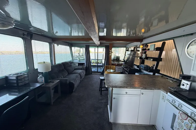 Slide: The Image of Interior of a 1997 Fun Country 56 houseboat with modern furnishings and large windows. - 17
