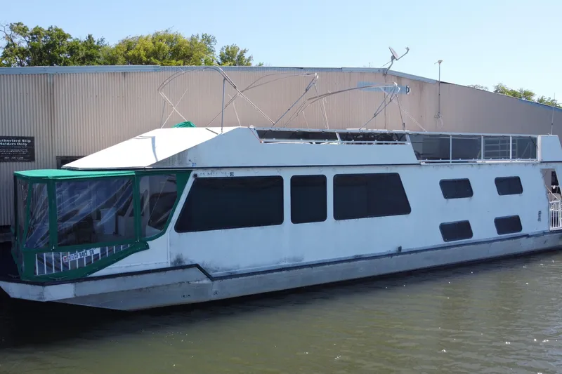 Slide: The Image of Houseboat docked by a warehouse, Fun Country 56 model, 1997. - 2