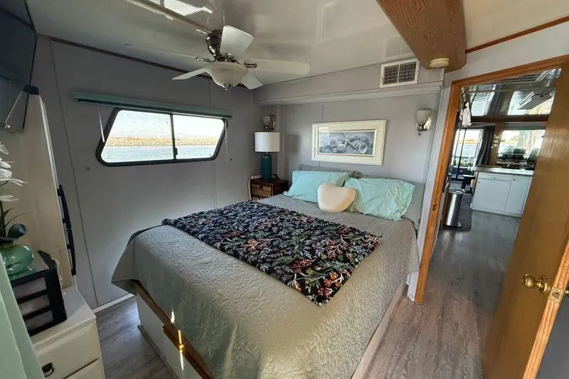 Slide: The Image of Cozy bedroom in 1997 Fun Country 56 houseboat with floral bedding and modern decor. - 23