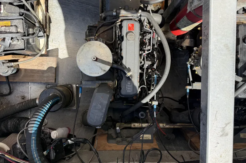Slide: The Image of Engine compartment of a 1997 Fun Country model 56 houseboat, showing mechanical components and wiring. - 8