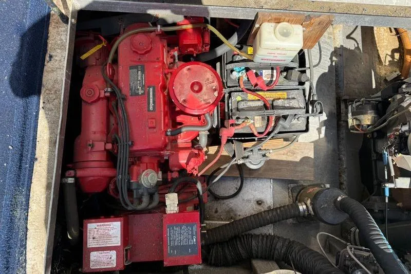 Slide: The Image of Engine compartment of a 1997 Fun Country 56, featuring a red motor and battery setup. - 9