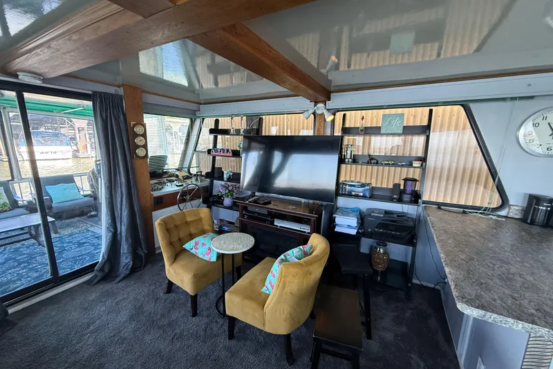 Slide: The Image of Cozy 1997 Fun Country houseboat interior with seating, TV, and decor. - 20