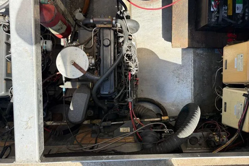 Slide: The Image of Engine compartment of a 1997 Fun Country 56, featuring various mechanical components and wiring. - 7