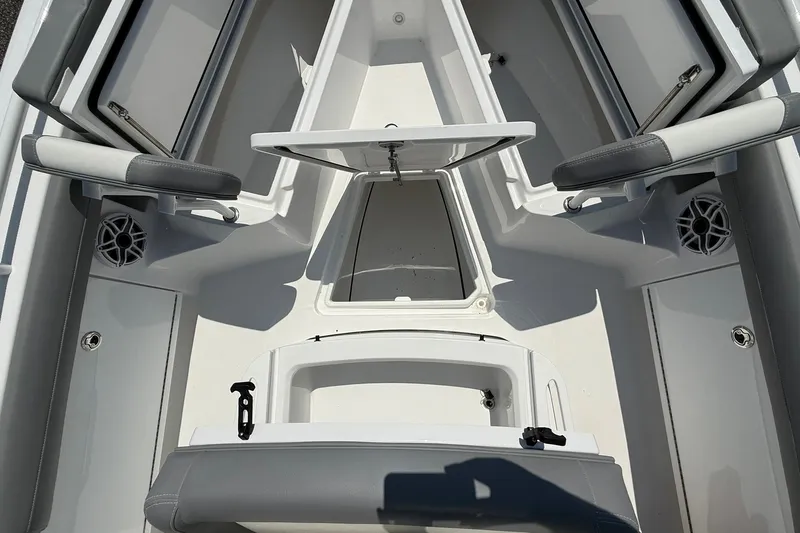Slide: The Image of 2026 Everglades 253 Center Console boat interior with open storage compartments and seating. - 27