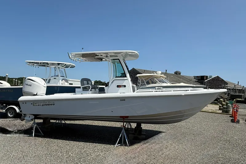 Slide: The Image of 2026 Everglades 253 Center Console boat displayed outdoors on a sunny day. - 3