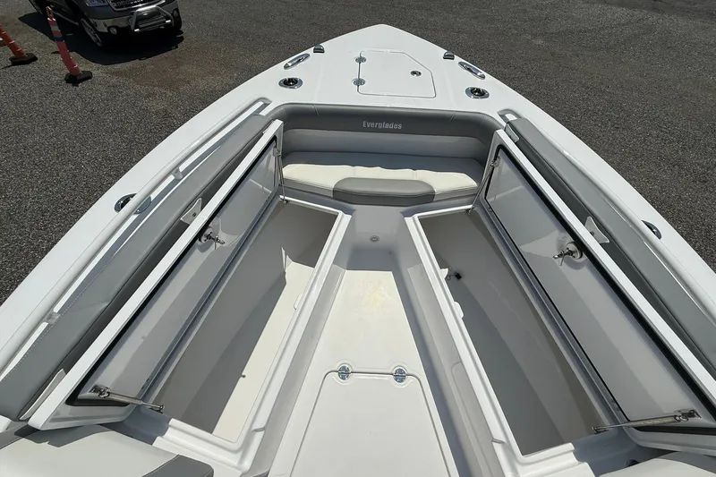 Slide: The Image of 2026 Everglades 253 Center Console boat with open storage compartments on deck. - 26
