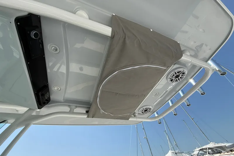 Slide: The Image of 2026 Everglades 253 Center Console boat roof with speakers and storage compartment. - 19