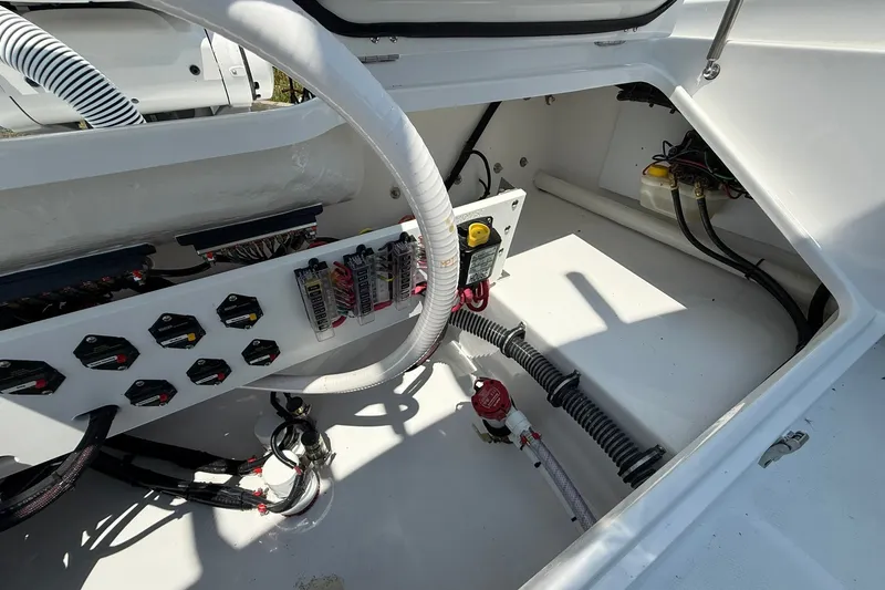 Slide: The Image of Electrical compartment of 2026 Everglades 253 Center Console boat, showcasing wiring and components. - 16