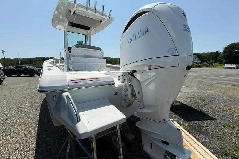 Slide: The Image of 2026 Everglades 253 Center Console boat with Yamaha engine, parked on gravel lot. - 9