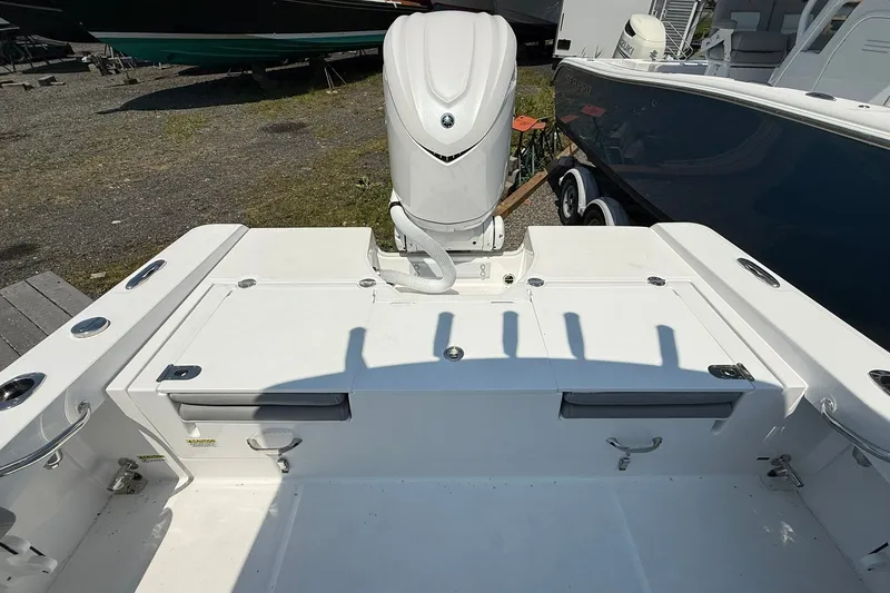 Slide: The Image of 2026 Everglades 253 Center Console boat interior with engine and storage compartments. - 13
