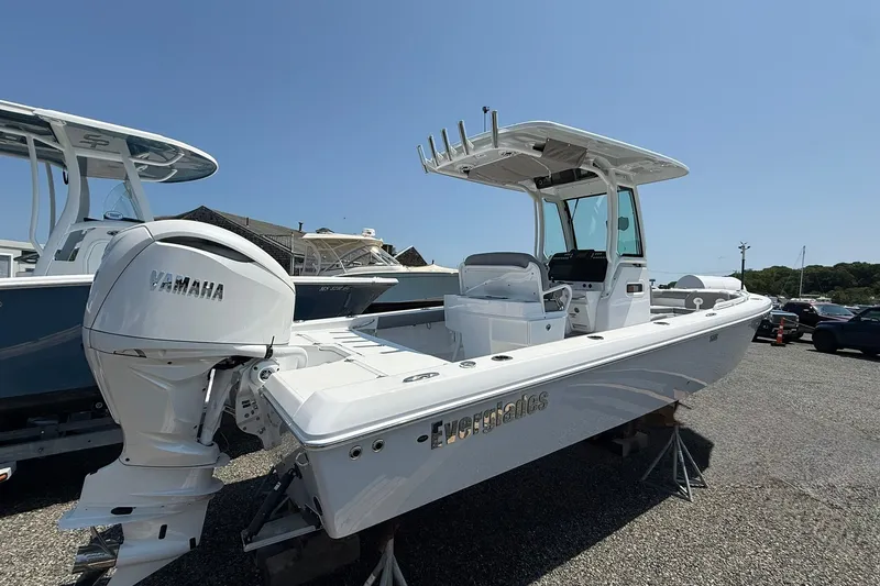 Slide: The Image of 2026 Everglades 253 Center Console boat with Yamaha engine, parked outdoors. - 7
