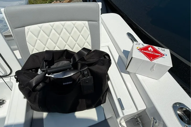 Slide: The Image of Black bag and flammable liquid box on Everglades 253 Center Console boat seat, 2026 model. - 33