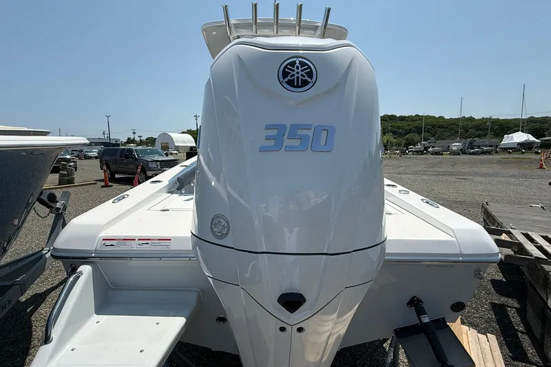 Slide: The Image of 2026 Everglades 253 Center Console boat with powerful 350 engine, parked outdoors. - 8