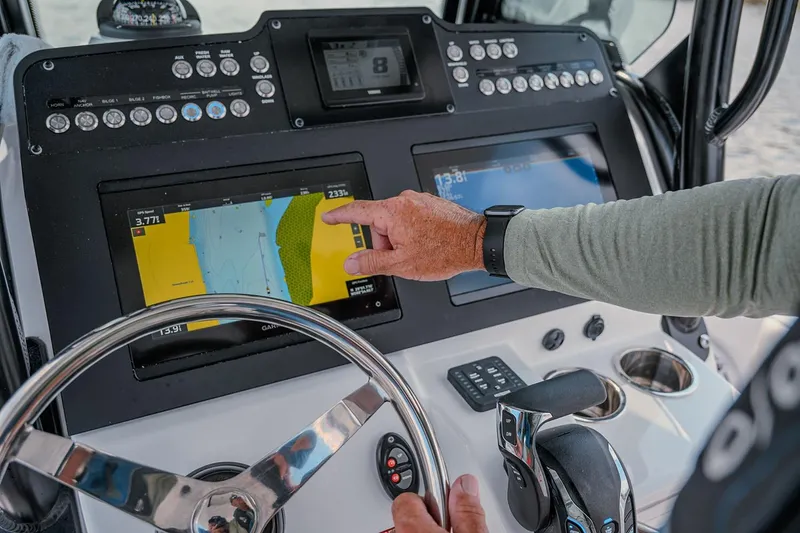 Slide: The Image of Manufacturer Provided Image: 2025 Everglades 253 Center Console dashboard with navigation screens and steering wheel. - 5