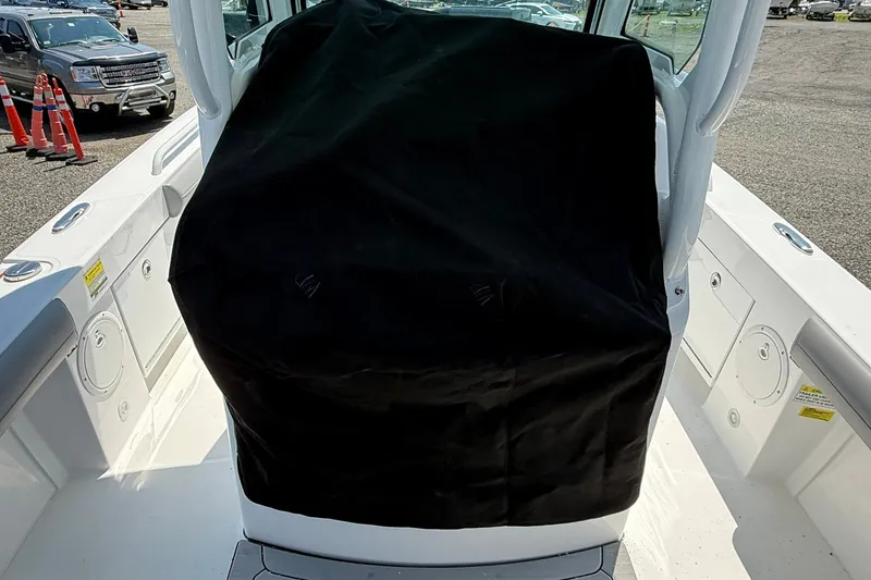 Slide: The Image of 2026 Everglades 253 Center Console boat interior with covered console, parked outdoors. - 11