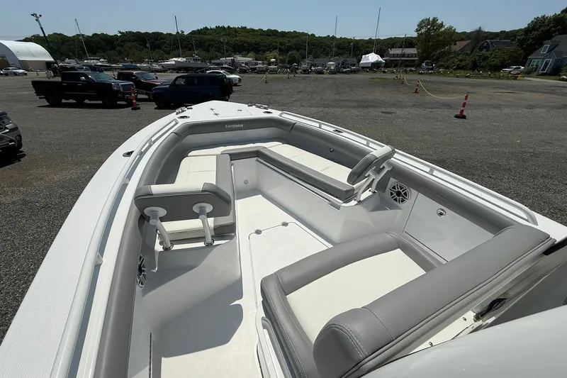Slide: The Image of 2026 Everglades 253 Center Console boat with spacious seating, parked outdoors. - 25