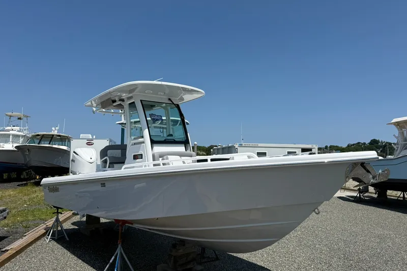 Slide: The Image of 2026 Everglades 253 Center Console boat on display under clear blue sky. - 2