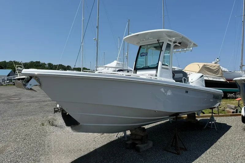 Slide: The Image of 2026 Everglades 253 Center Console boat on display in a marina setting. - 1