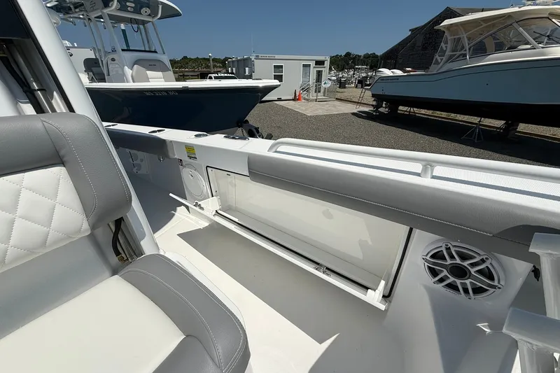 Slide: The Image of 2026 Everglades 253 Center Console boat interior with seating and storage compartments. - 23