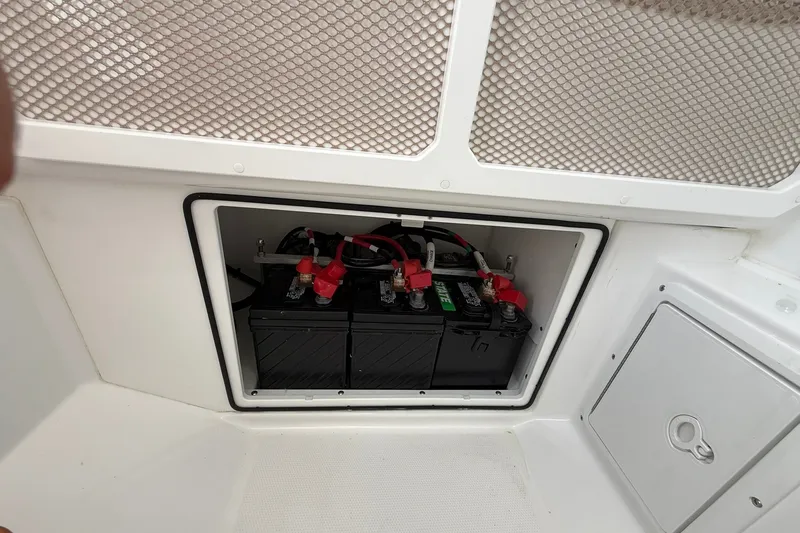 Slide: The Image of Battery compartment of 2026 Everglades 253 Center Console boat, featuring dual batteries. - 31