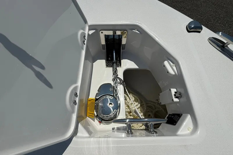 Slide: The Image of Anchor compartment of 2026 Everglades 253 Center Console boat, featuring a neatly stored anchor chain. - 29