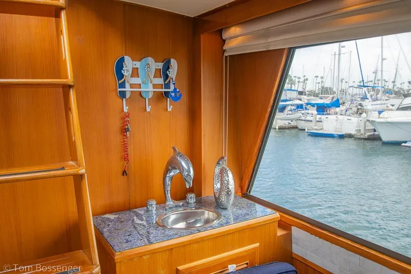 Slide: The Image of Interior of 1990 Kha Shing Flush Deck Motor Yacht with marina view and nautical decor. - 15